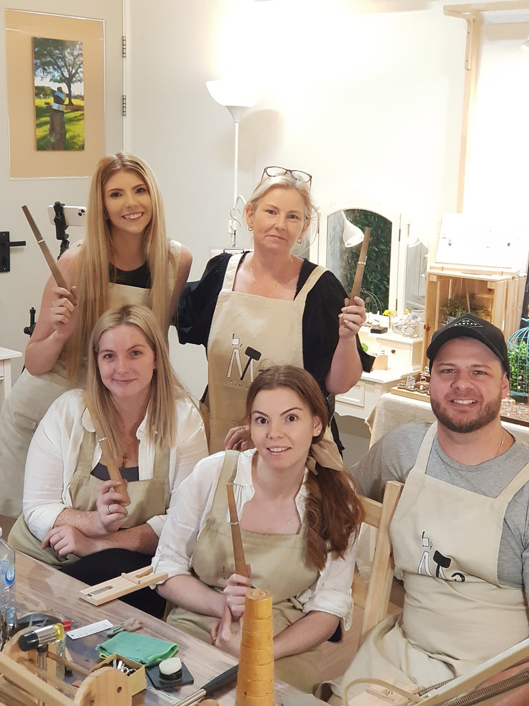 Happy family of 5 posing with their beautiful handmade silver rings on a stick after their Ring-Making Class at enchanted Jewellery-Making Workshop: ByMe Workshop, Brisbane.