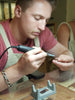 A male is using a polishing machine to polish a 9ct gold ring during a Couple Ring-Making Class at the Enchanted Jewellery-Making Workshop: ByMe Workshop, Brisbane